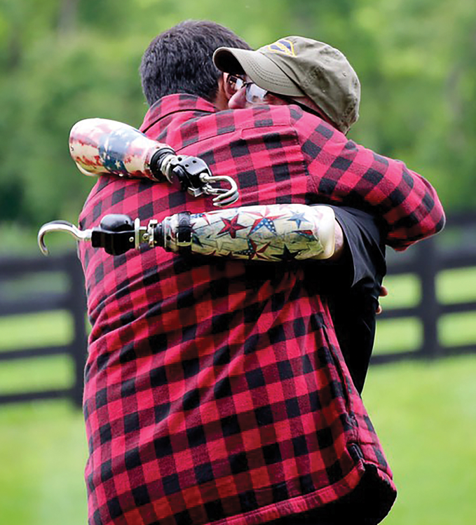 A disabled veteran shares a hug with Josh