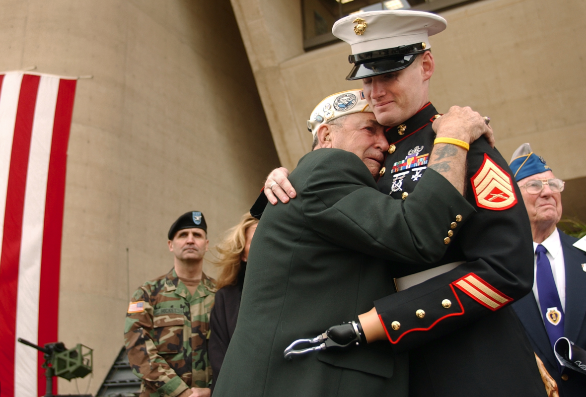 A disabled soldier hugs a veteran