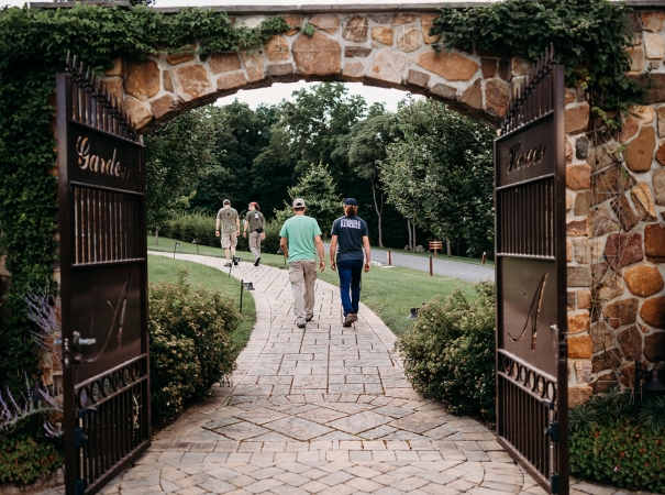 A group of men walking through a gate