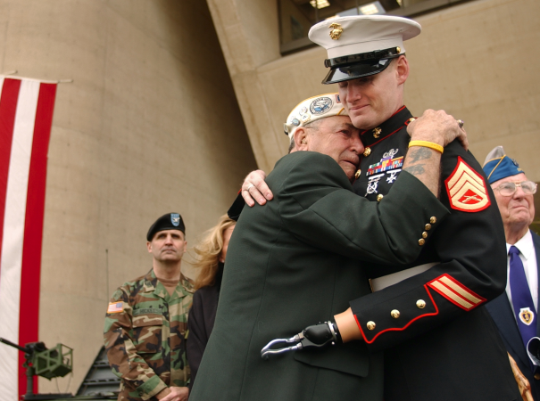 A disabled soldier hugs a veteran